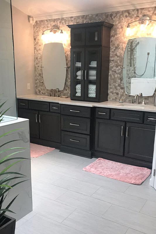 Bathroom design features builtin bathroom storage cabinets with white countertop, double sink with mirror