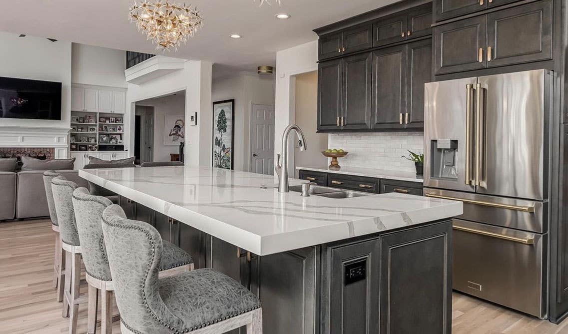 Kitchen with York Driftwood Grey cabinets and island with marble countertop