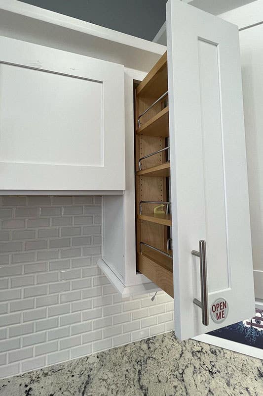 bright white shaker cabinets with silver pulls and custom storage solutions