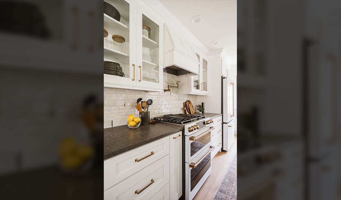 white cabinet with glass door and Range hood, subway tile backsplashes 