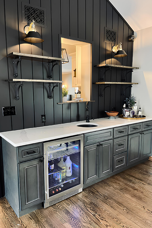 Wet bar area feature floating shelves, Gray cabinets and inbuild wine rack 