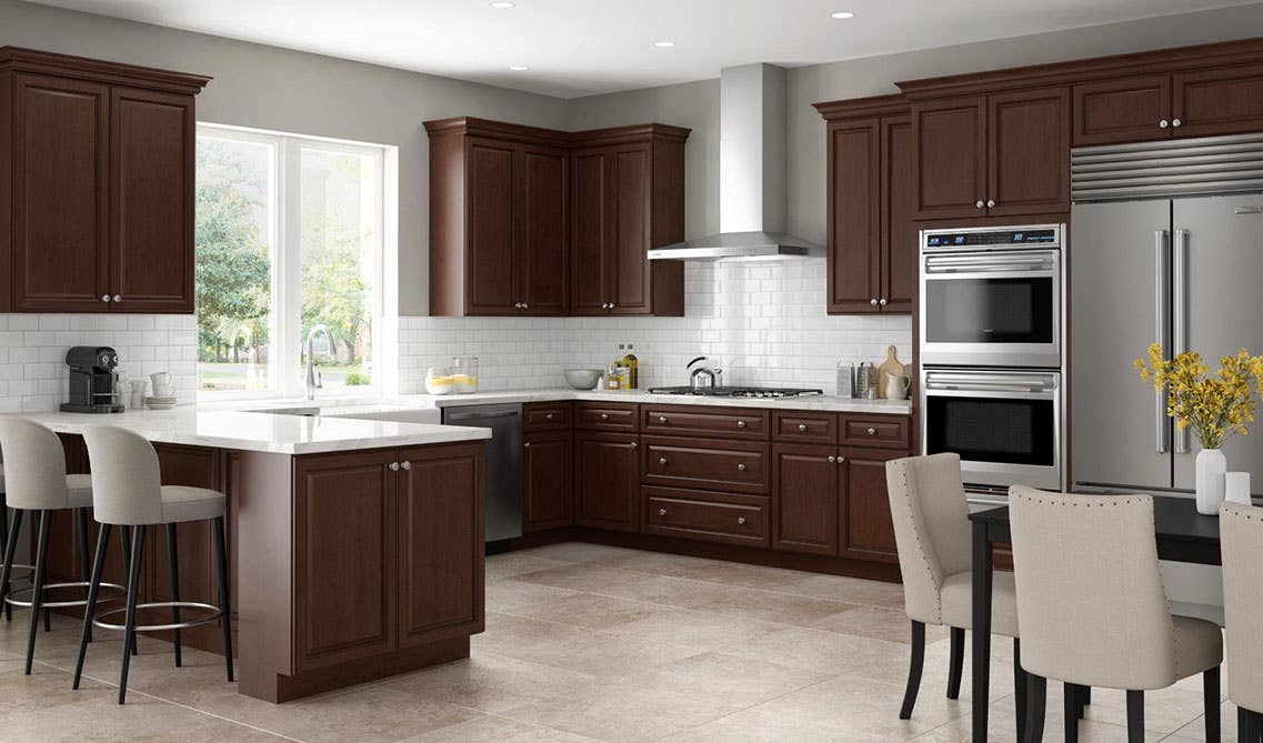 Kitchen with chocolate kitchen cabinets,, stainless steel appliances and white marble countertop