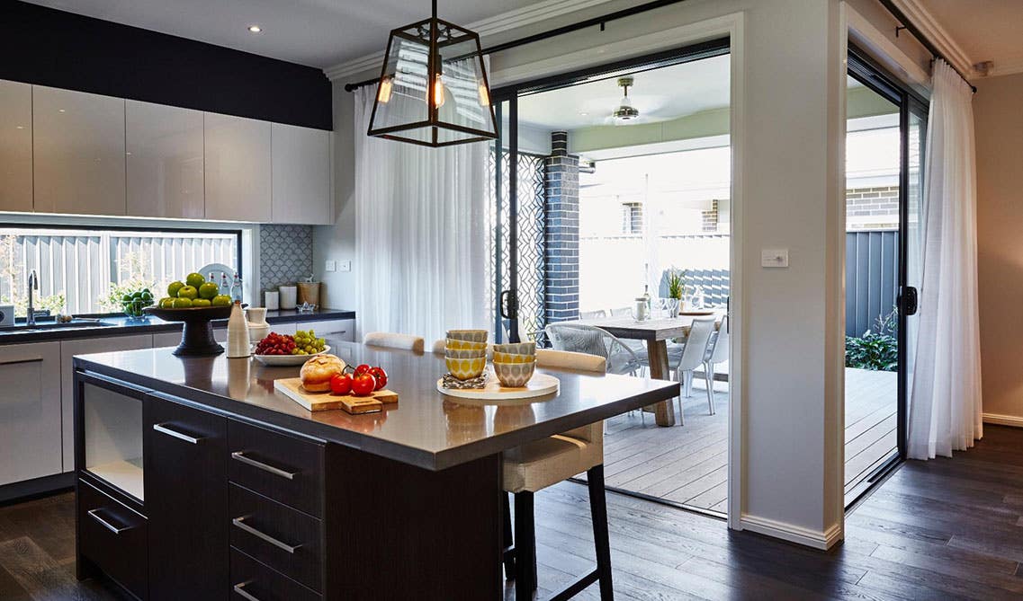 Open kitchen design with flat panel cabinets, functional island connected with large window theme