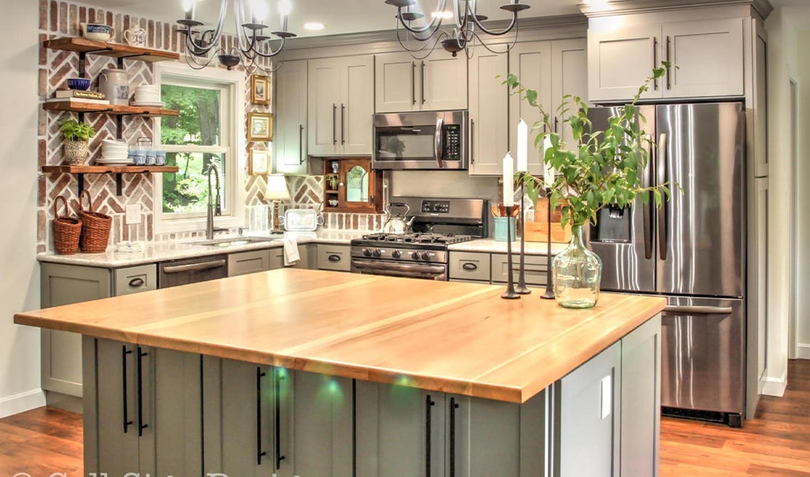 L shape cabinets paired with small island and gray cabinets, open shelving, stainless steel appliances 