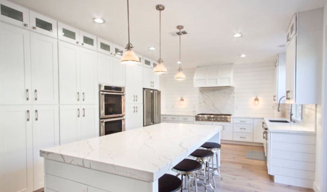 white kitchen with shaker cabinets and large island