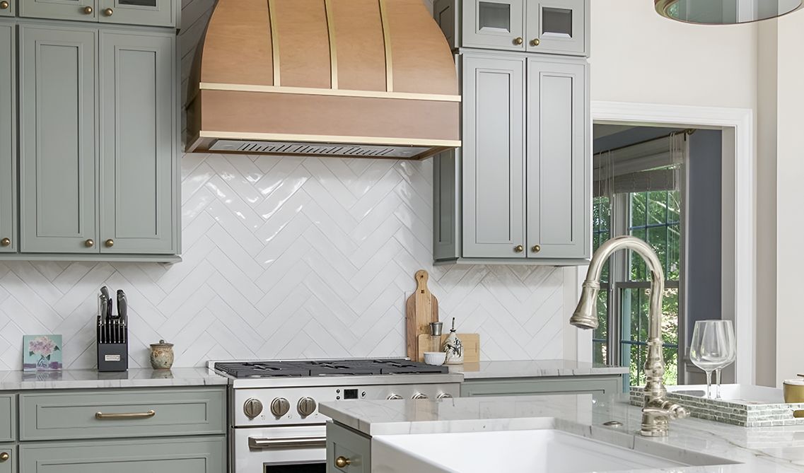 kitchen design show casing Craftsman Lily Green cabinets, wood hood, functional island and marble countertop
