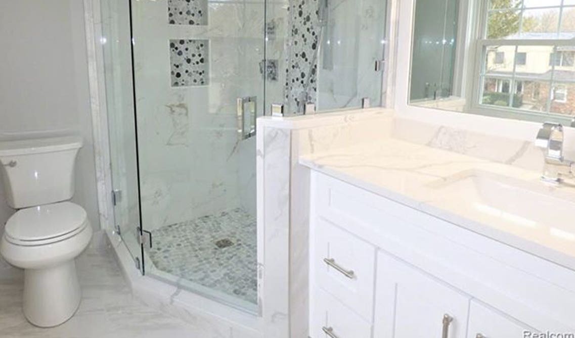 walk-in shower with sleek glass doors and sophisticated tile designs