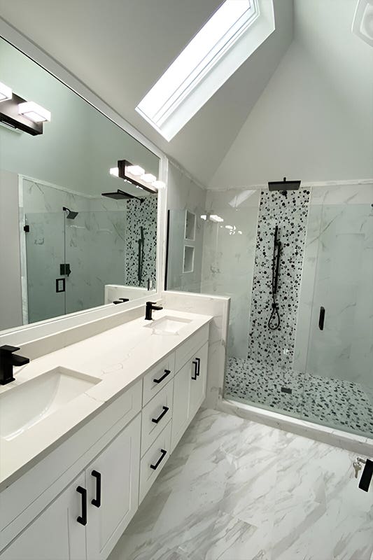 White bathroom vanity with marble countertop and matt black hardware