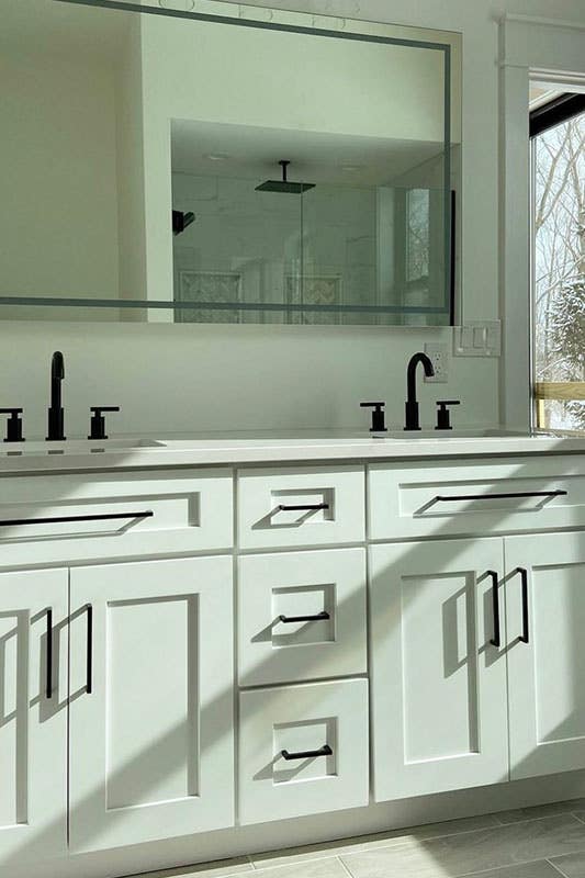 White shaker bathroom vanity with marble countertops, black matt fitting and fixtures, large rectangle mirror 