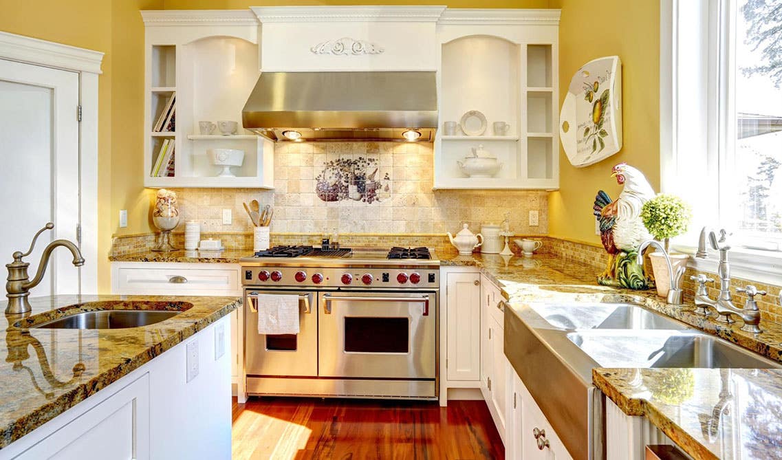 Mellow yellow wall with white cabinets kitchen design