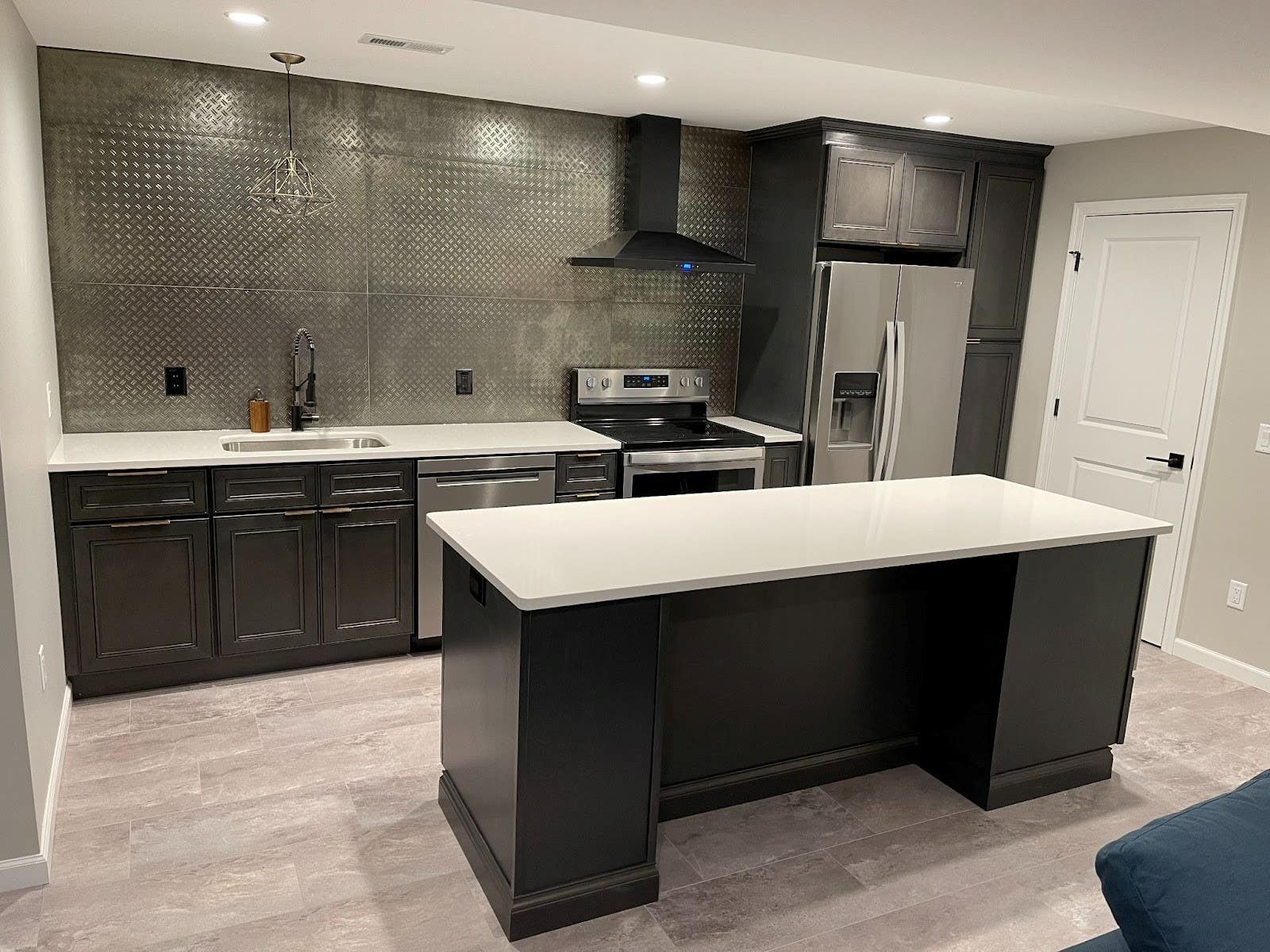 Metal Backsplash paired with dark cabinets