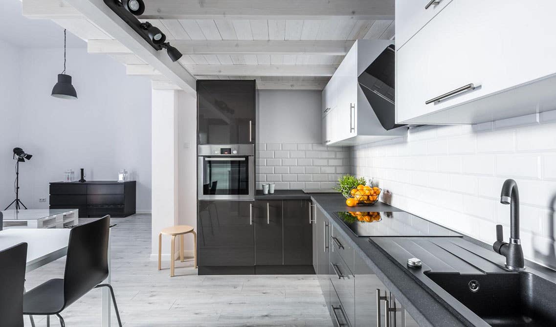 Two tone black and white kitchen cabinets with white subway tile backsplashes 