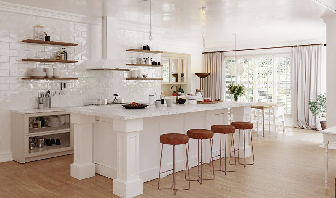 White Kitchen Cabinets with big white countertop, bar and stools