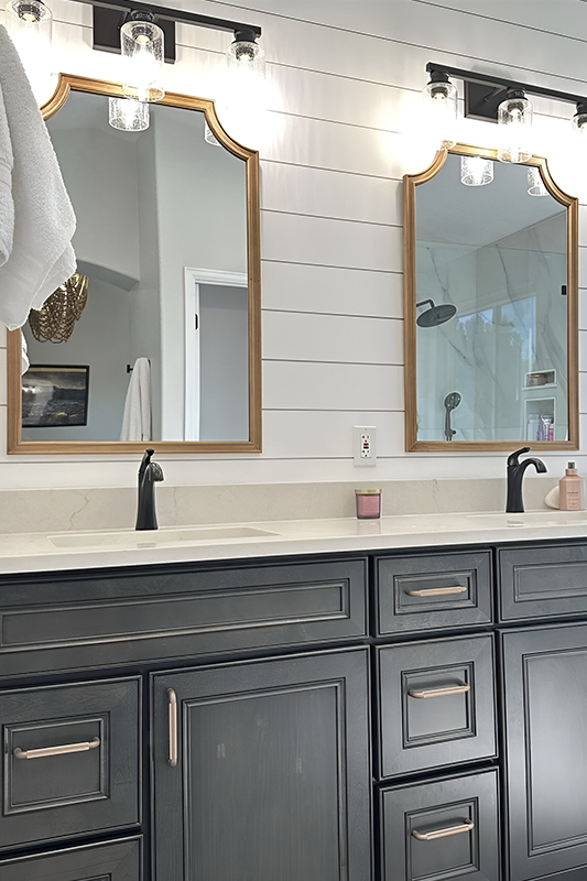 Driftwood gray bathroom vanity paired with black and gold fitting and fixture