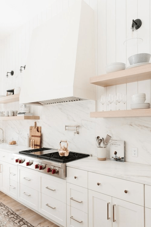 white slab marble backsplash with white cabinets and marble countertop