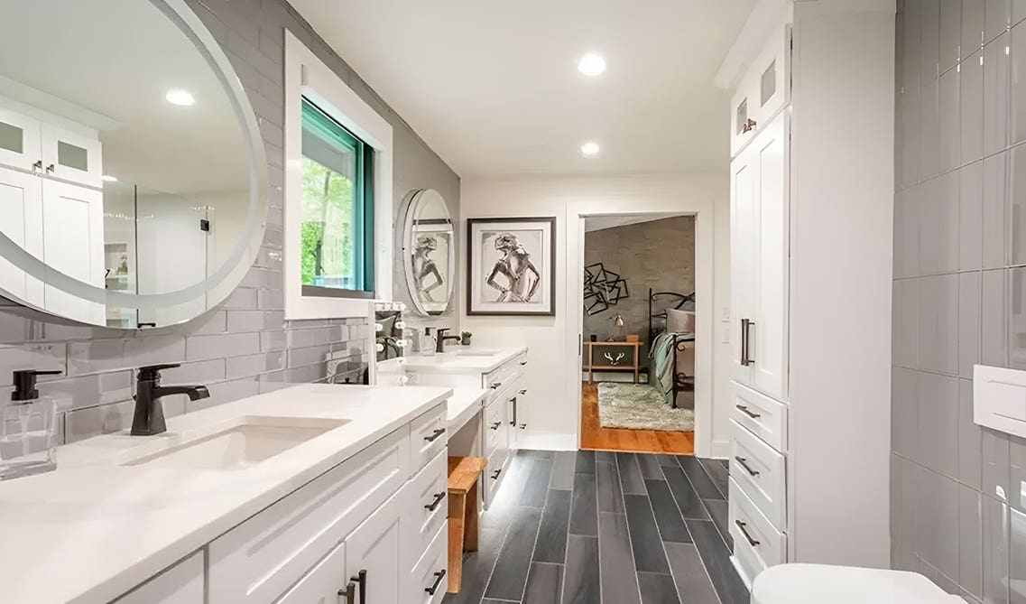 Modern white bathroom paired with white countertop, gray tile backsplash and black matt fixtures 
