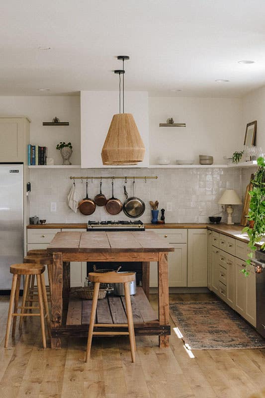 Modern Farmhouse kitchen with wooden island and chair, cabinets, wood countertop and open shelves 