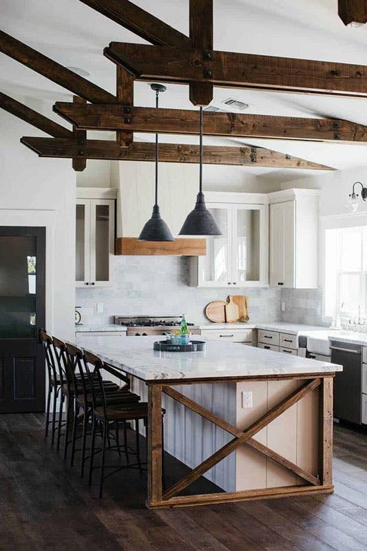 modern farmhouse kitchen with white accents, x-base island and wood beams