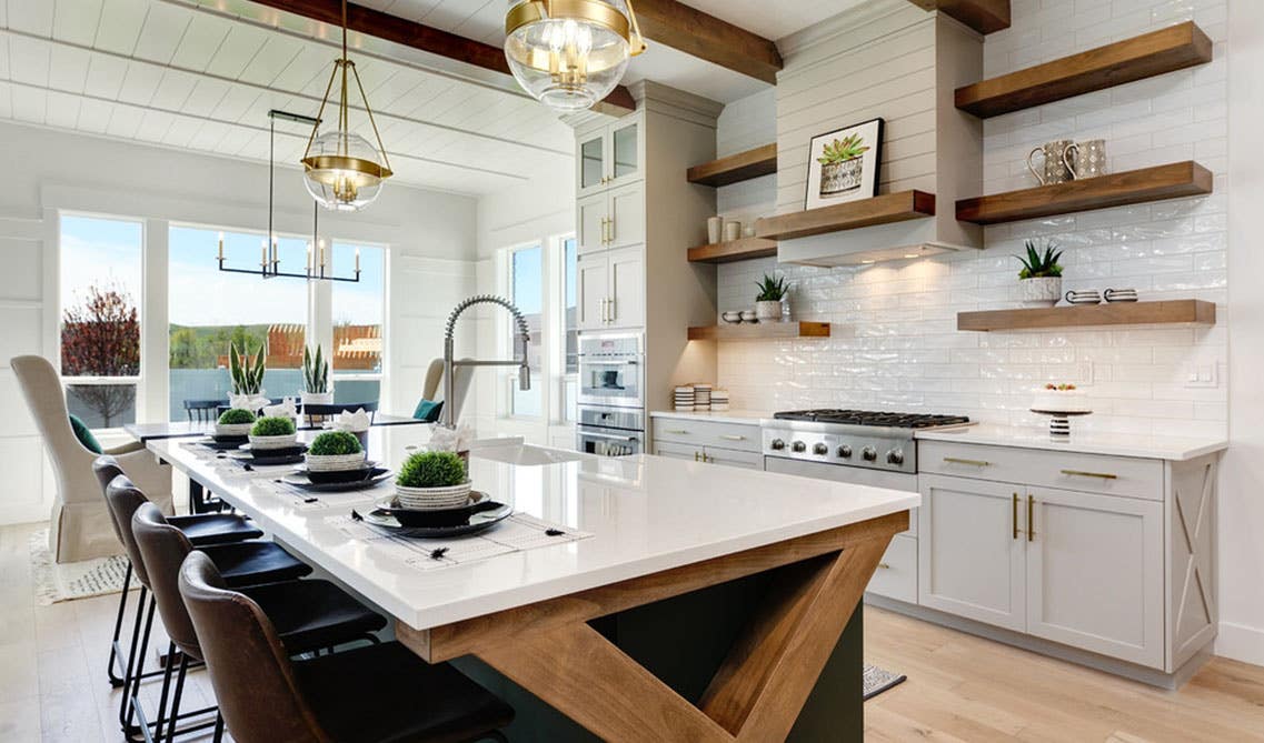 Modern Farmhouse With Glossy Tile, large island with sink and chairs