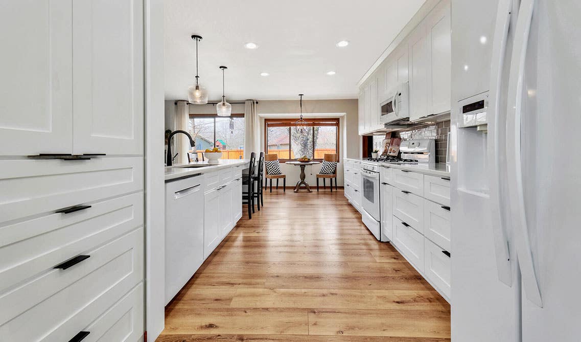 Modern kitchen with White Shaker Elite Cabinets and SPC flooring 