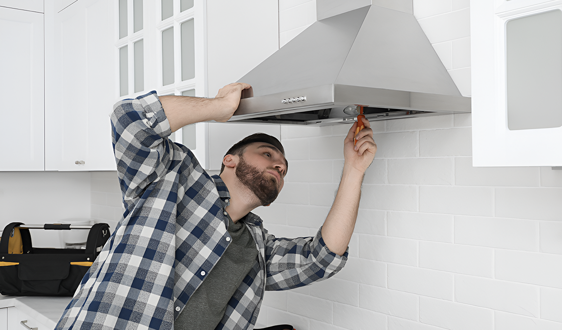 A man checking range hood