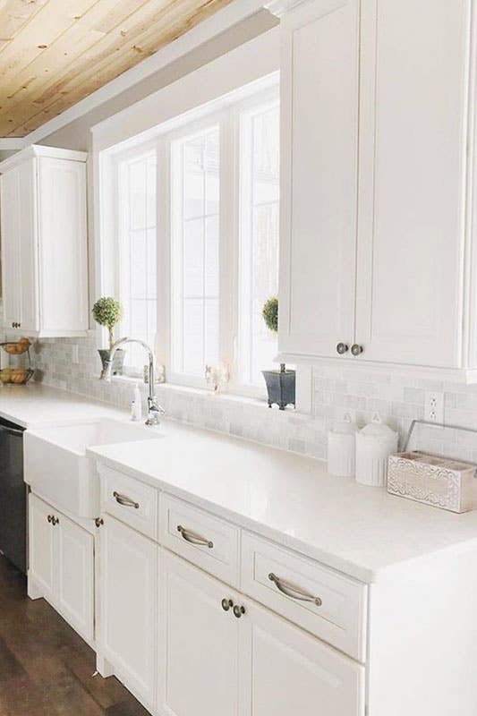 modern white kitchen design with shaker cabinets and countertop, undermount Ceramic sink and steel knob 