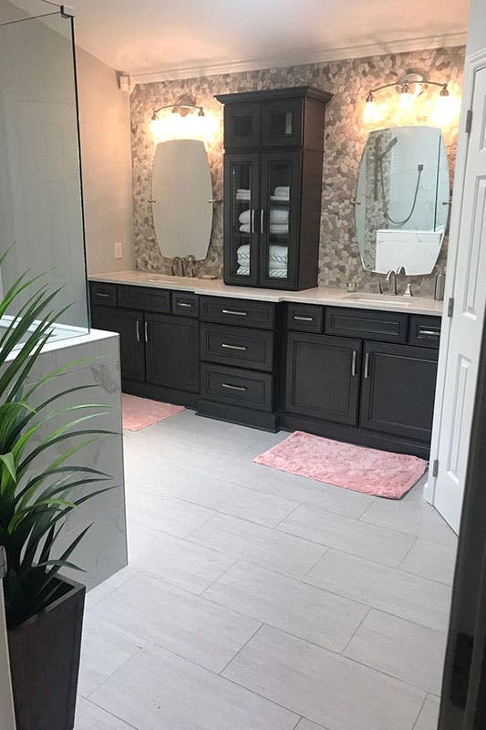 Bathroom with dark brown double sink vanity and Mosaic tiles