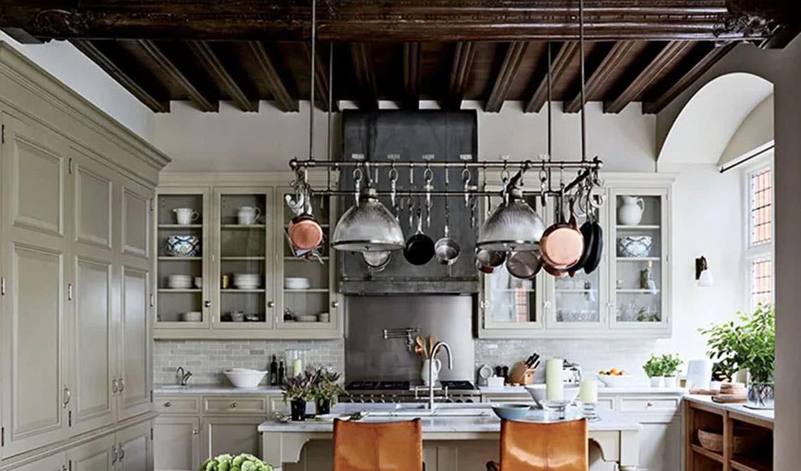 Rustic kitchen style with hanging pots and pans above island 