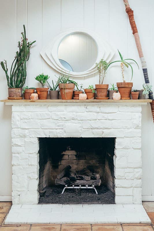 potted plants decor above White wood burning fireplace