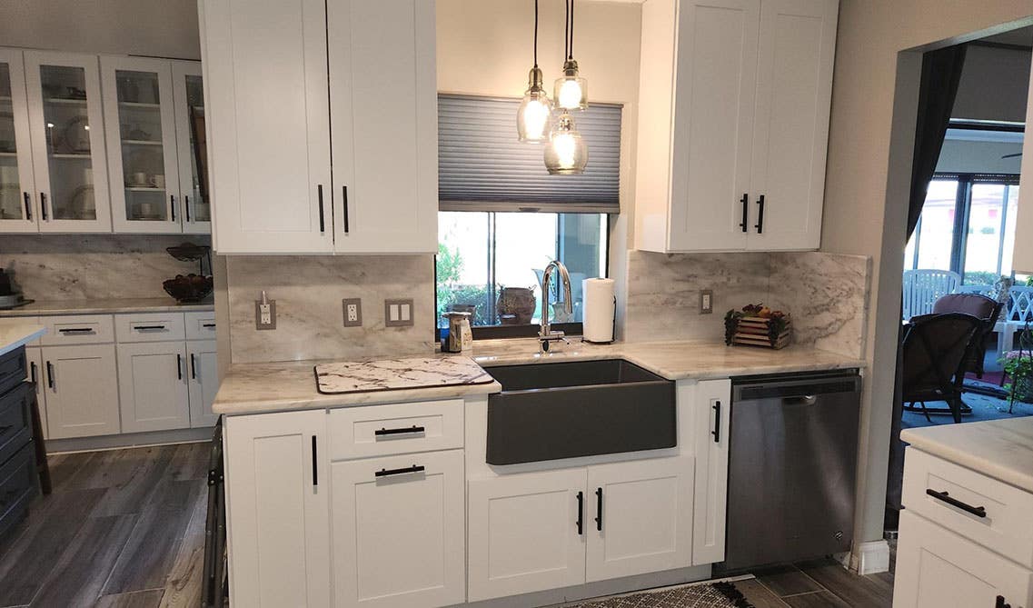 Natural stone backsplash with shaker cabinets