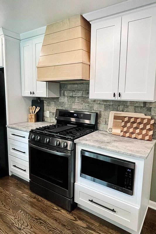 white cabinets paired with natural stone backsplash