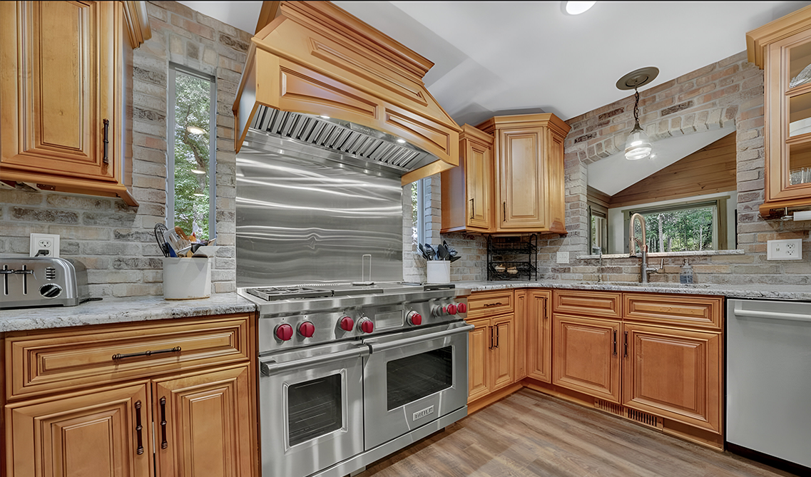 Natural wood kitchen cabinets paired with stainless steel appliances 