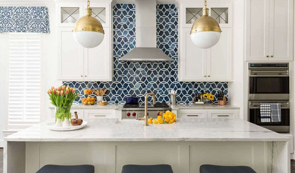 blue glass tile backsplash with striking white cabinets