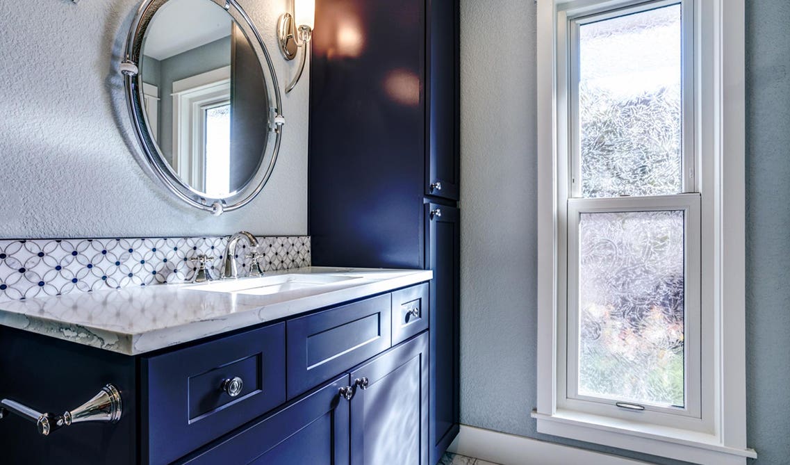 Navy Blue Bathroom vanity and round mirror