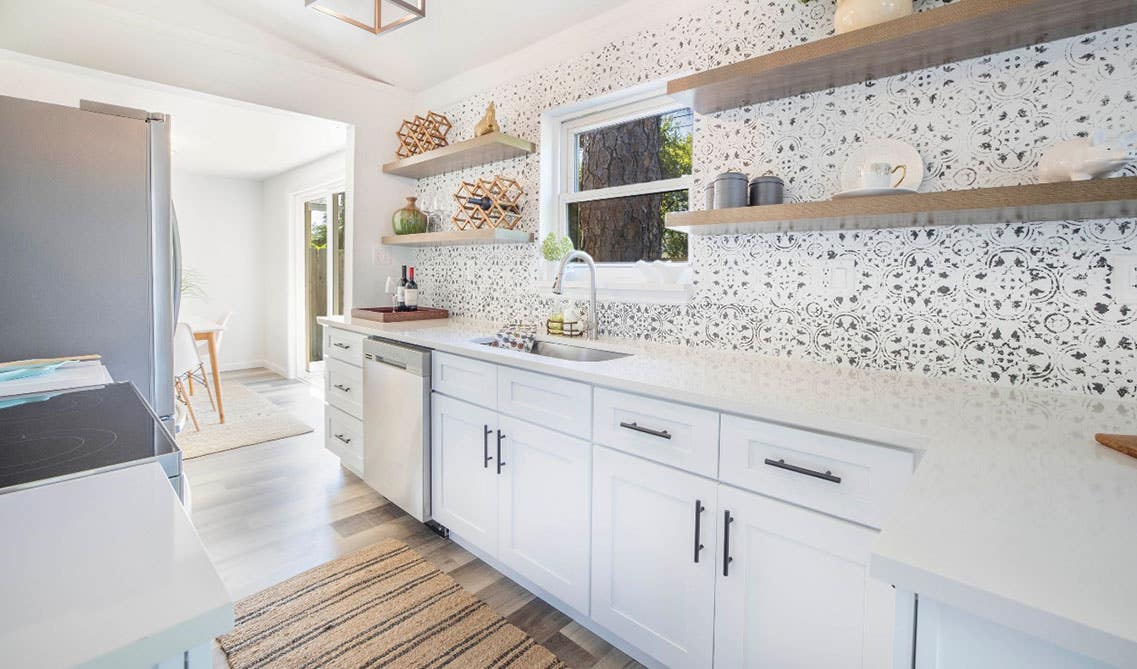 white kitchen cabinets with marble countertop and floating shelves