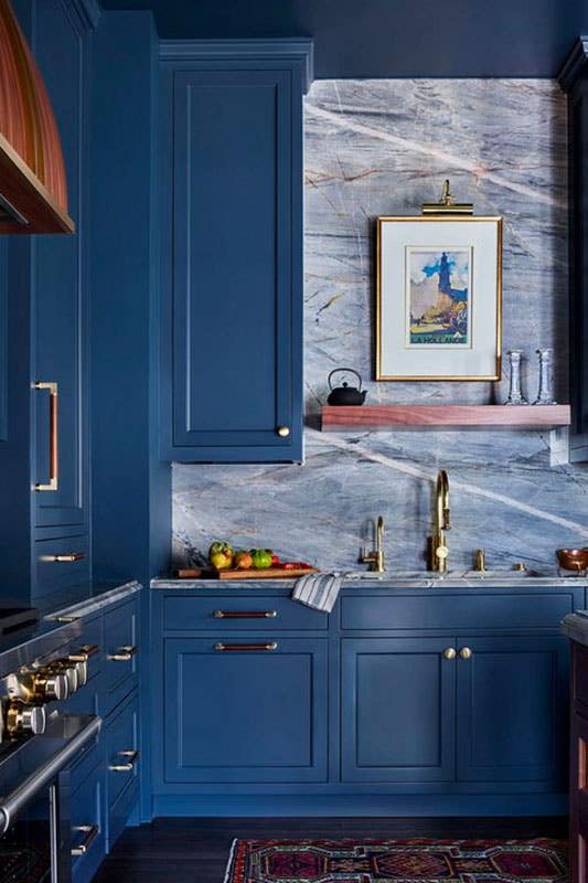 Ocean blue kitchen cabinets with marble backsplash tile 