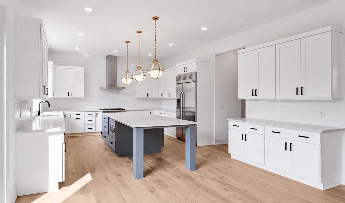 Open Kitchen Design paired with white shaker cabinets, white countertop, spc flooring and stainless steel appliances 