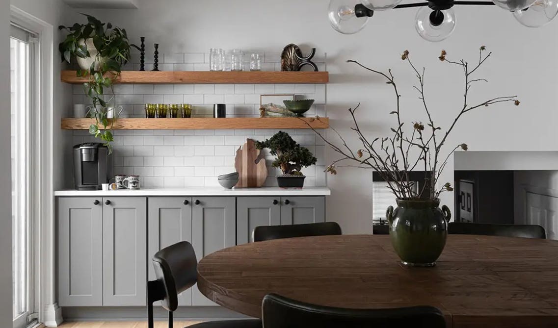 Open Shelving with gray shaker cabinets, Round wooden dining table, 