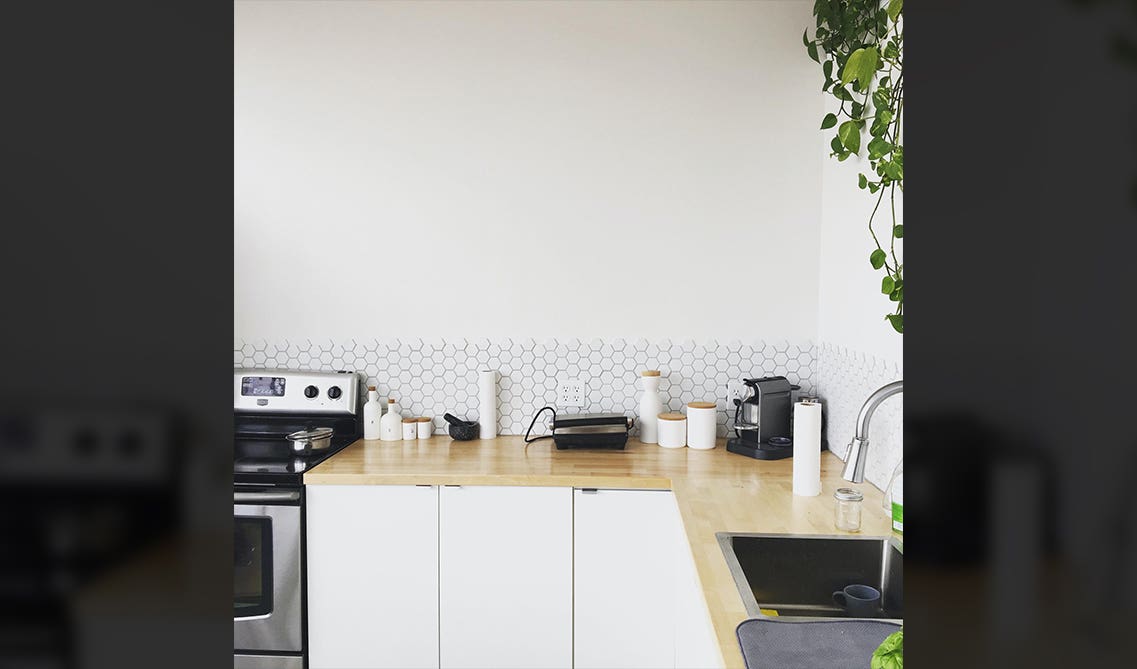 White cabinet with wood countertop and Peel and Stick Backsplash