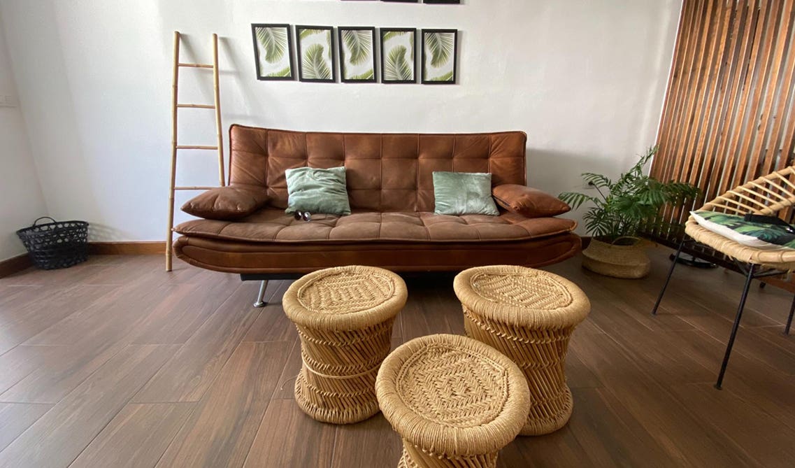 living room with brown sofa with pillow, 3 Bamboo Weaving Mudda Chair, wall, Vinyl Flooring 