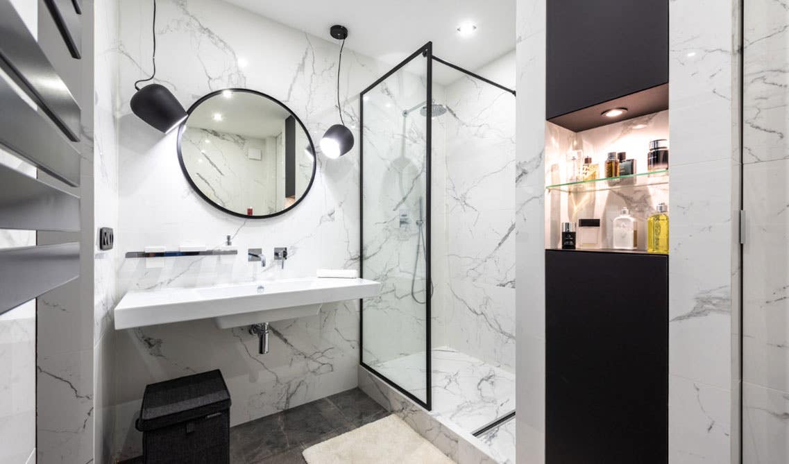 Beautiful white and black bathroom with pendant lights 