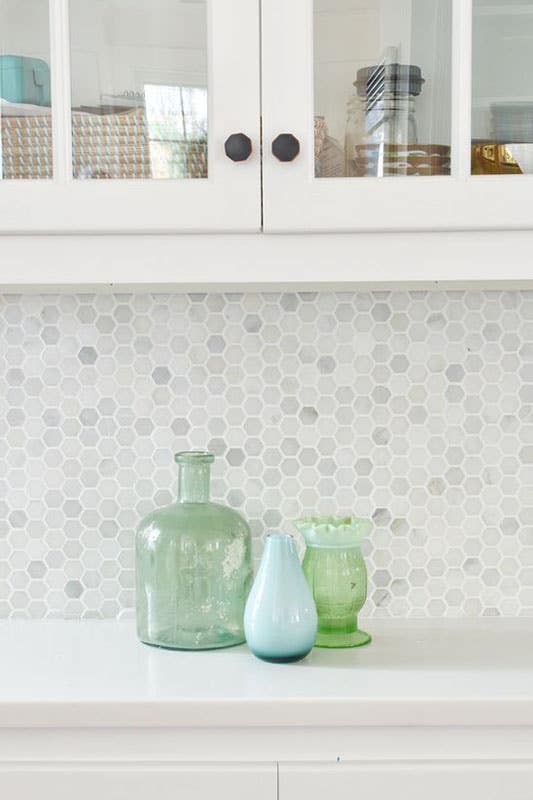 Modern kitchen with Penny Tile backsplash and white glass cabinets