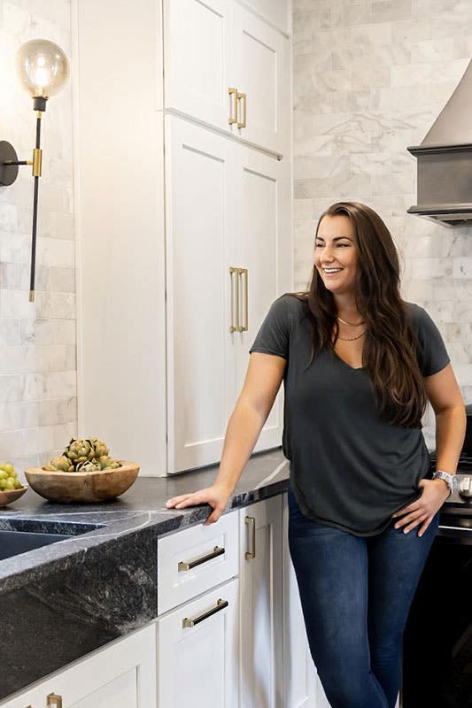 Personalized Kitchen Design with white cabinets and black hood, marble countertop