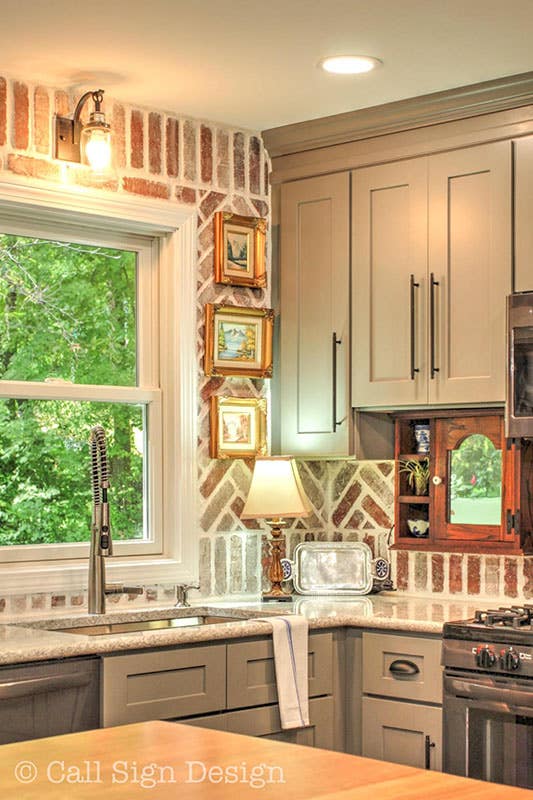 Personalized Kitchen Design with brick backsplash and photo Frame