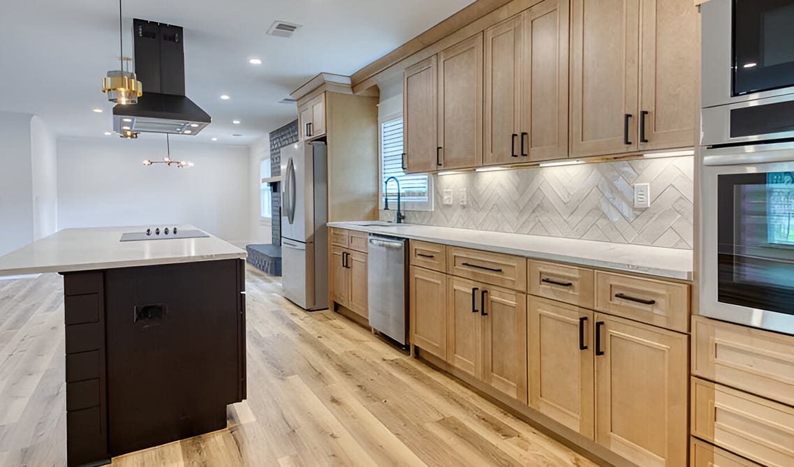 Plywood Cabinets paired with black matt hardware, marble countertop and laminate flooring 