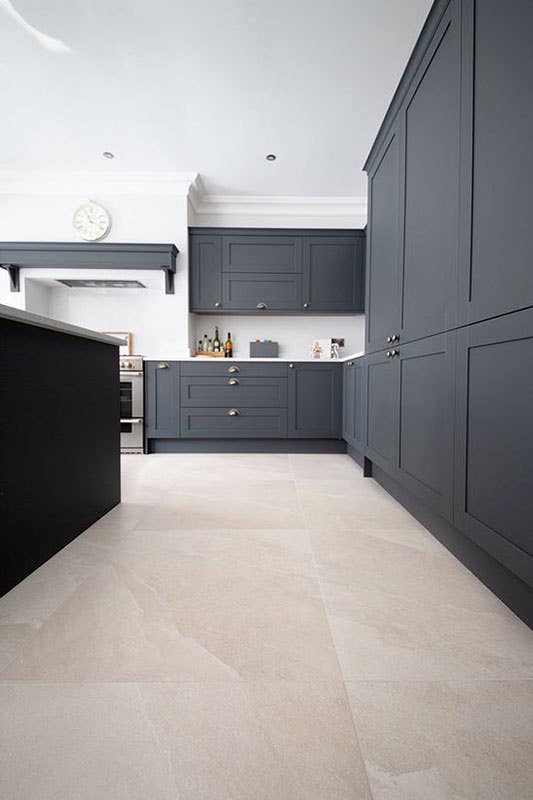 Porcelain Tile flooring with black kitchen cabinets