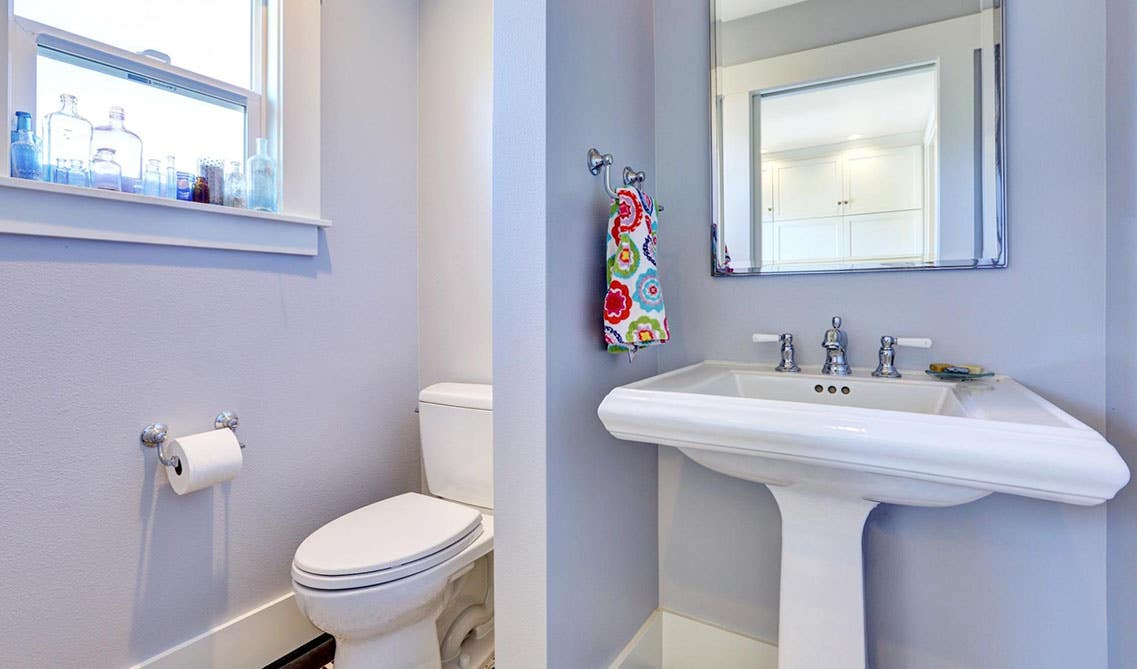 Bathroom design features privacy wall between sink and toilet sheet