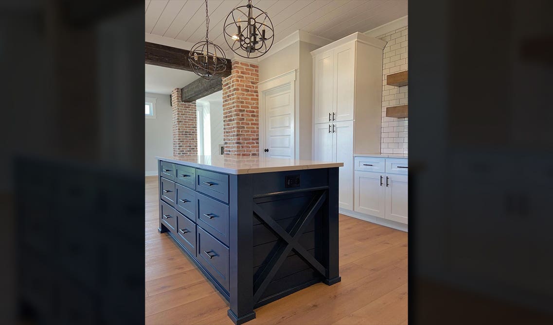 blue and white two toned kitchen cabinets with white subway tiles