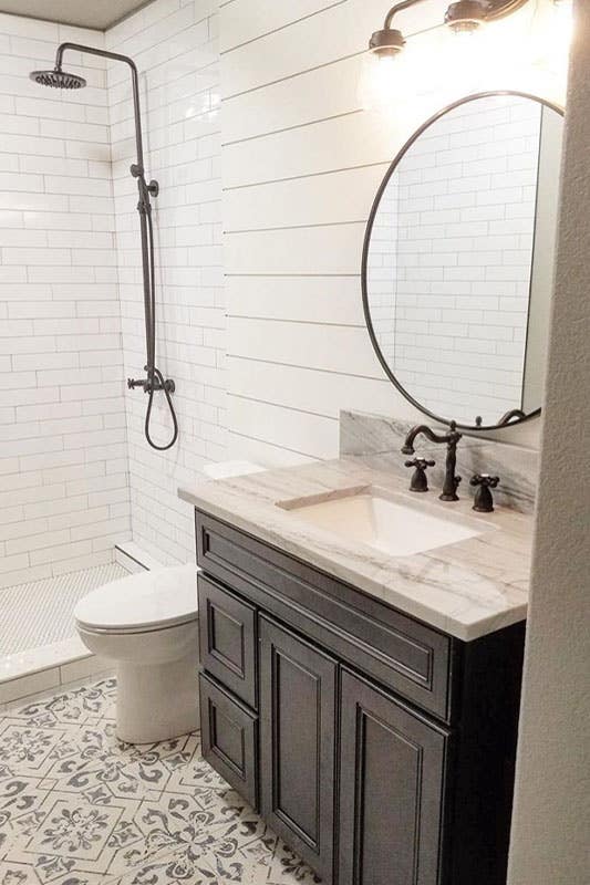 Bathroom design with rainfall showerhead, driftwood vanity with marble countertop and printed floor tile