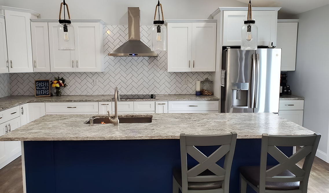 two tone kitchen cabinets paired with stainless steel range hood